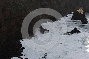 Waves breaking on the rocks of rugged Atlantic Ocean coast in Madeira Island, Portugal