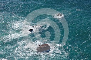 Waves breaking on rocks in sea