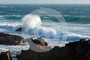 Waves breaking on rocky coast.