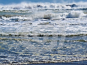 Waves breaking and rolling on beach background