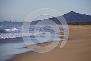 Waves breaking on sandy beach