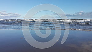 Waves breaking on sandy beach