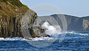Waves breaking on sea cliffs