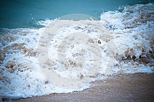 Waves breaking on the shore and transformed into a foam. Selective focus