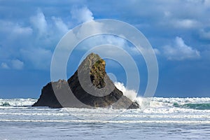 Waves breaking on tiny, rocky Paratahi Island, New Zealand