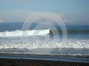 Waves breaks into surf along beach