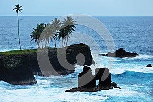 Waves and cliffs of a coast of sao tome and principe photo