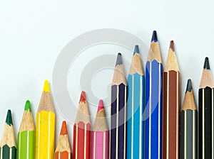 Waves of colored pencils on a white background