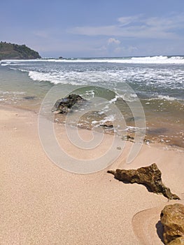 Waves, coral reef, stone and sky