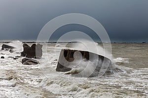 Waves crash against the forts in a stormy sea