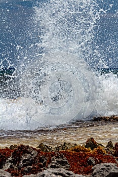 Waves crash against rocks in caribbean sea
