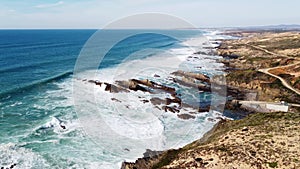 Waves crash against the rocky headlands of the western Portuguese coast on rainy days