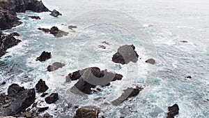 Waves crash against the rocky headlands of the western Portuguese coast on rainy days