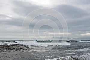 Waves crash ashore on Hvalnes beach on Hvalnes peninsula in southern Iceland.