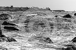 The waves crash on the cliff of Forio in Ischia