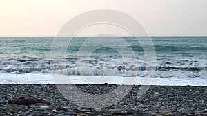 Waves crash on the pebble shore. Black Sea coast. A storm warning.