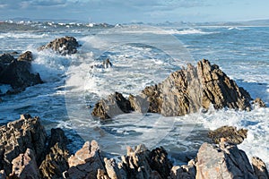 Rough waves crashing on rocks in Kleinbaai, South Africa