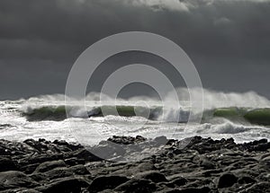 Waves crash on to the rocks and beaches of a cornish coastline,
