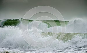 Waves crash on to the rocks and beaches of a cornish coastline,