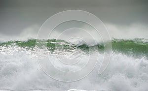 Waves crash on to the rocks and beaches of a cornish coastline,