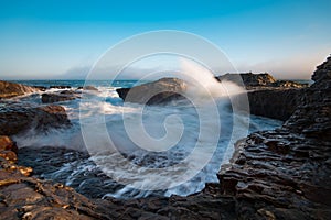 Waves crash in a torrent on the coast of Davenport California