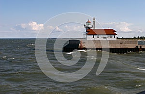 Waves crashing against a Lake Superior light house pier