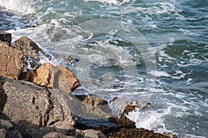 Waves are crashing against rocks in Brittany (France)