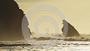 Waves Crashing Against Rocks at Orange Sunrise, Beautiful Rugged Rocky Coastal Scenery and Coastline