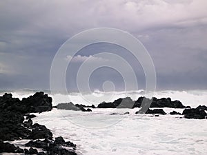 Waves crashing against rocks. Piscinas Naturais Caneiros Natural Park