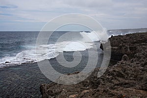 Waves crashing against rocks at the shore in Tonga