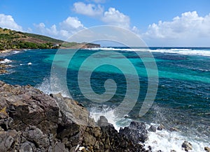 Waves crashing against rocks in the windward islands