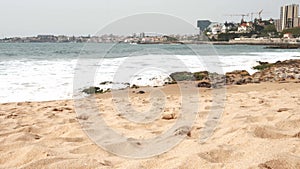 Waves crashing on a beach by the Atlantic Ocean in Cascais, Portugal