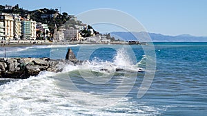 The waves crashing on the breakwater