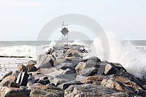 Waves crashing on jetty rocks