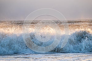 Waves crashing onto Alnmouth Beach, Northumberland, at sunrise.