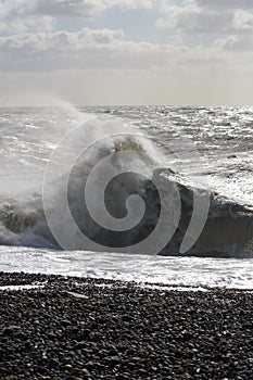 Waves crashing onto pebble beach`