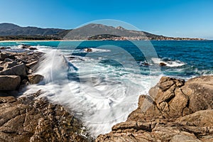 Waves crashing onto rocks near Algajola beach in Corsica