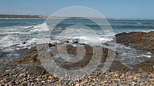 Waves crashing onto the rocks at the seashore