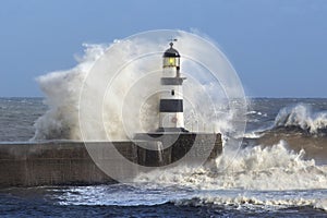 Waves crashing over Lighthouse - England