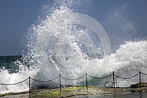 Waves crashing over the railing to the Bogie Hole photo