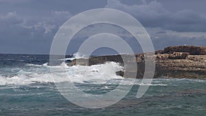 Waves crashing over rocks in the ocean