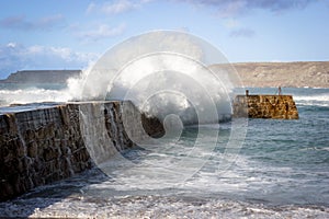 Waves crashing over the sea wall