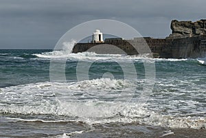 Waves crashing the Pier at Portreath, Cornwall UK