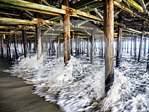 Waves crashing the pillars under the Santa Monica Pier - Santa Monica, Los Angeles, LA, California, CA