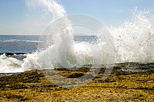 Waves crashing on rocks photo