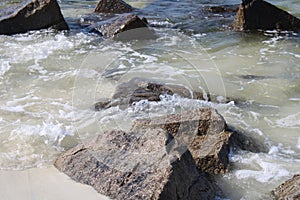 Waves crashing on rocks along a shoreline