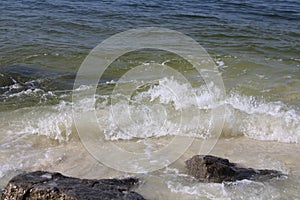 Waves crashing on rocks along a shoreline
