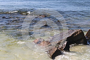 Waves crashing on rocks along a shoreline