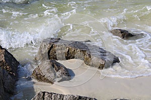 Waves crashing on rocks along a shoreline