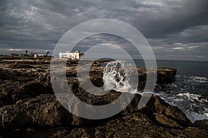 Waves crashing on rocks in Apulia